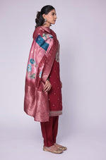 Flat lay arrangement of the complete maroon soft silk suit set, featuring the embroidered kurta, printed jacquard dupatta, and matching pants, showcasing the full design.