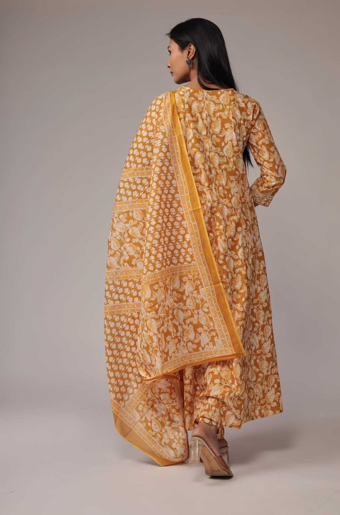Back view of the printed mustard yellow Anarkali dupatta set, showing the elegant fall of the Anarkali and the consistent print.
