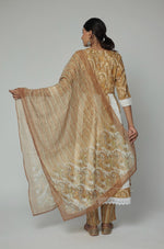 Back view of the mustard yellow and white Schiffli Anarkali dupatta set, showing the elegant flare and consistent pattern on the kurti and comfortable silhouette.