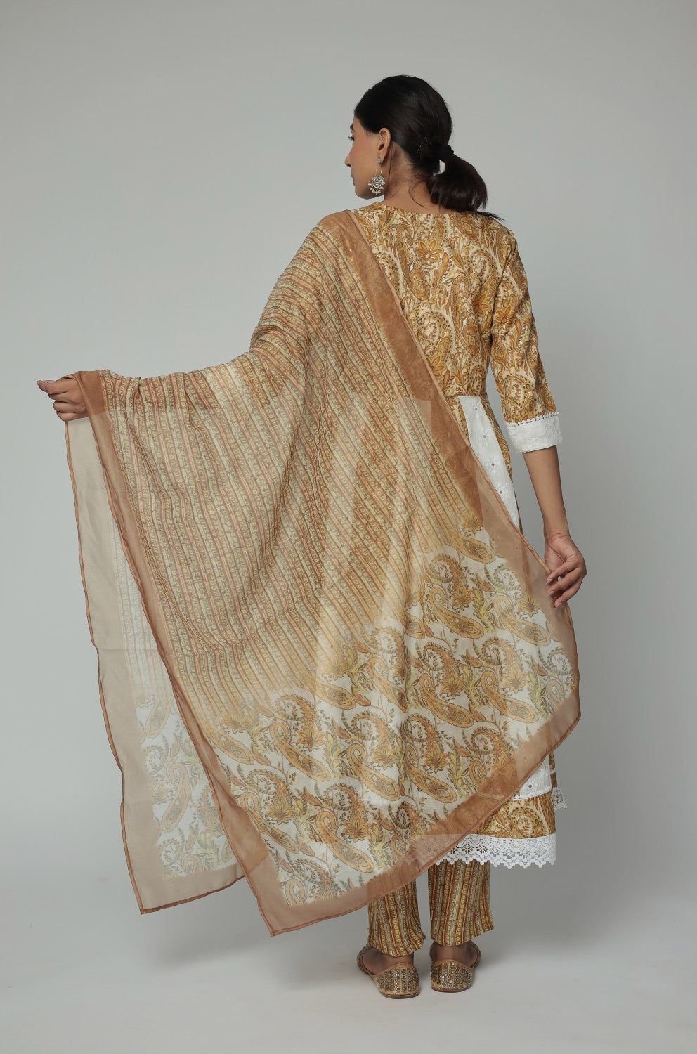 Back view of the mustard yellow and white Schiffli Anarkali dupatta set, showing the elegant flare and consistent pattern on the kurti and comfortable silhouette.