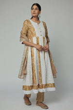 Model in a relaxed stance, highlighting the full length and comfortable design of the mustard yellow Schiffli Anarkali set with mirror work.