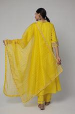 Back view of the beautiful mustard yellow Schiffli kurta set with cotton pant and organza dupatta, showing the elegant flow and consistent design.