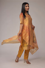 Model gracefully posing in the Banarasi Jacquard Chanderi mustard suit, showcasing the fluidity and rich drape of the jacquard dupatta.
