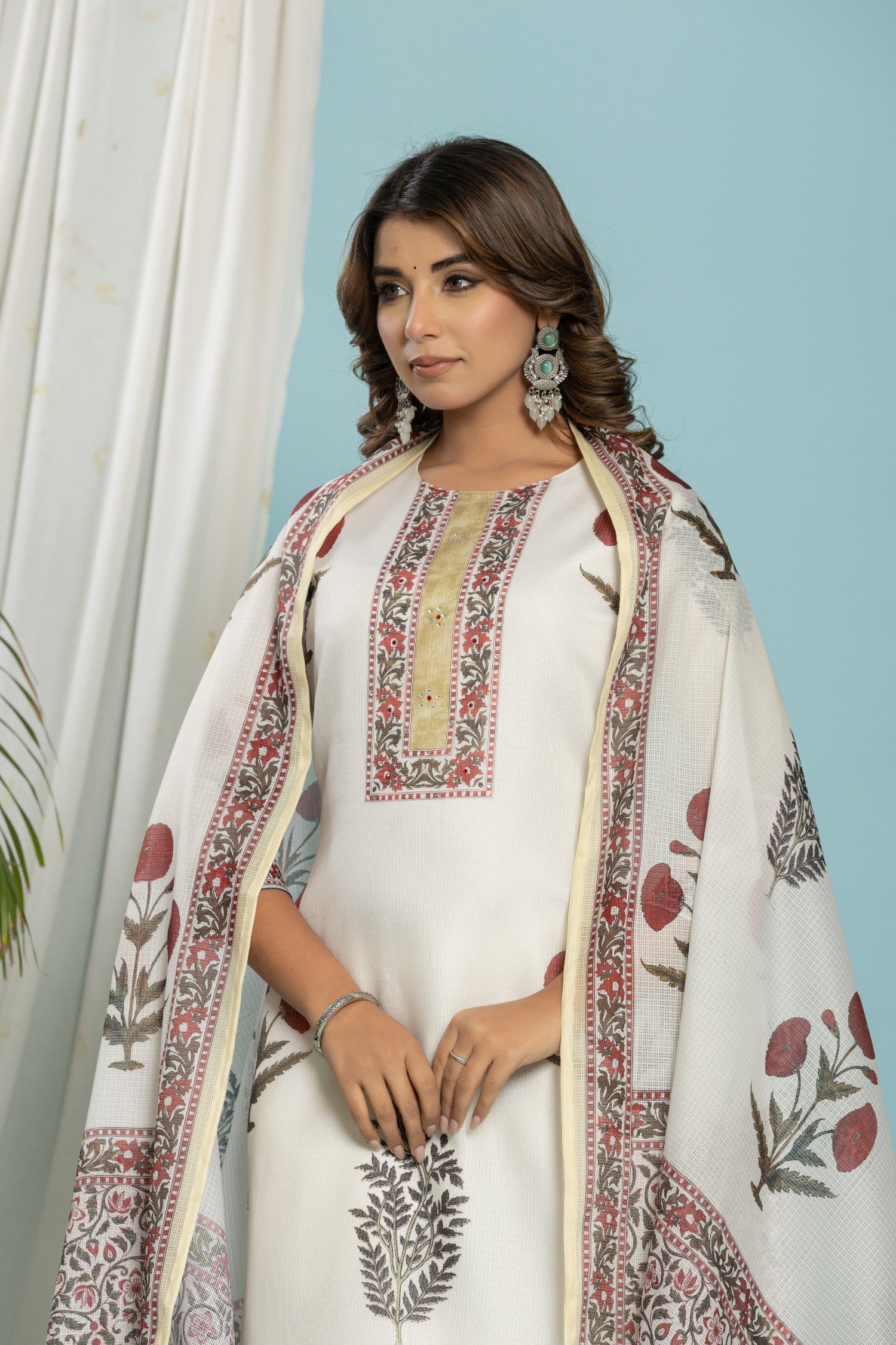 Close-up of the traditional red and black floral block print design on the off-white kurti of the Kota Doria set, with gold neck detail.