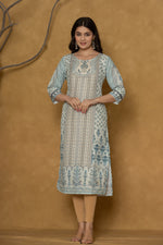 Model in a confident stance, highlighting the full length and overall detailed pattern design of the pastel blue kurta with handwork.

