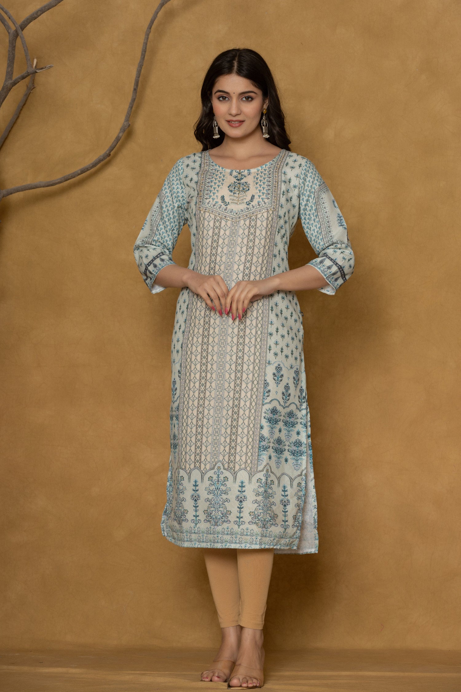 Model in a confident stance, highlighting the full length and overall detailed pattern design of the pastel blue kurta with handwork.

