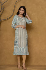 Model gracefully posing in the pastel blue kurta with handwork, showcasing the comfortable movement and elegant style of the ethnic wear.