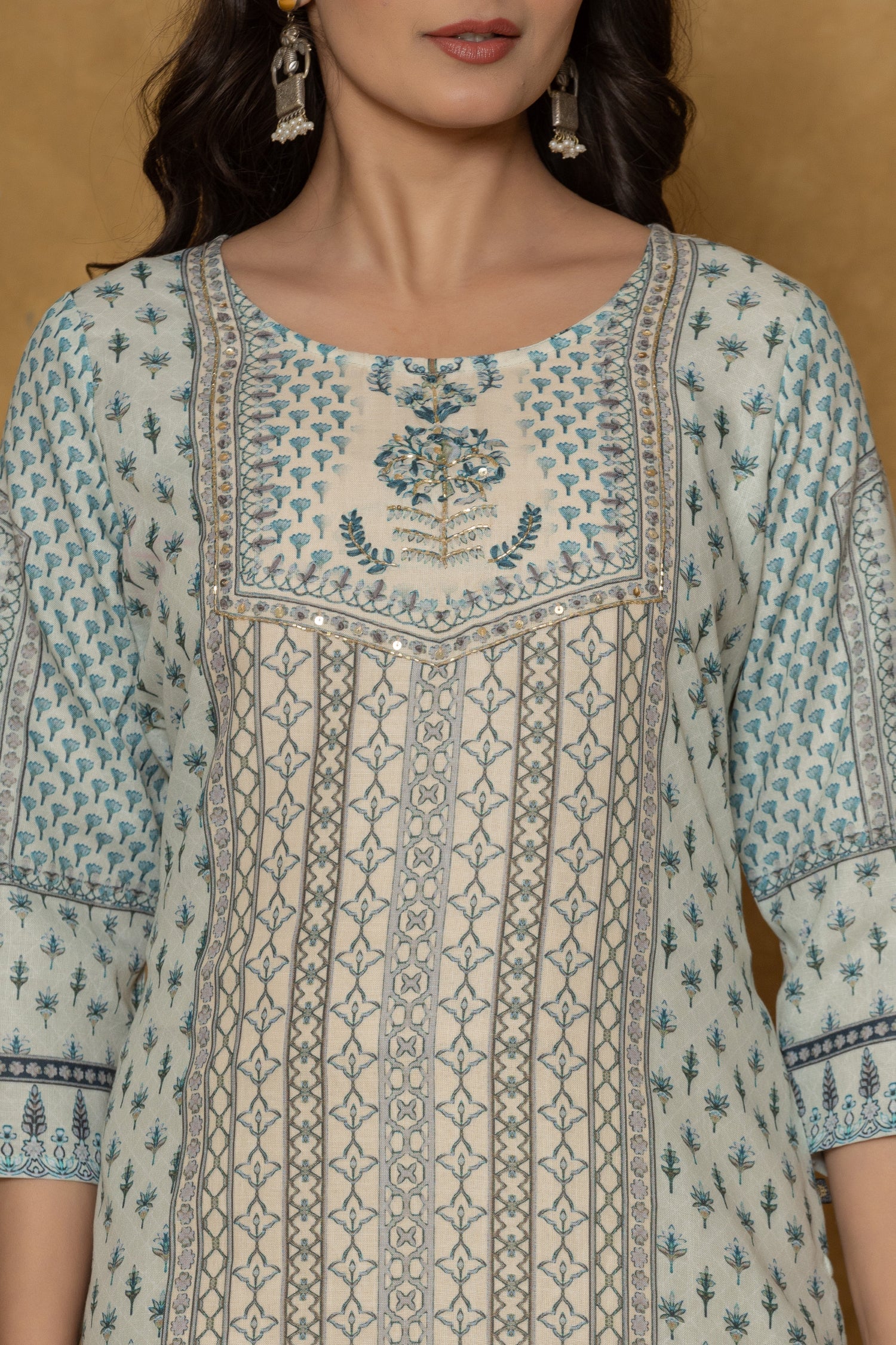 Close-up of the beautiful white handwork embroidery and intricate detailing on the round neckline of the pastel blue kurta, highlighting fine craftsmanship.