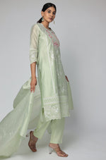 Model gracefully showcasing the long, trailing drape of the pestal green Chanderi dupatta with subtle embroidery, from the suit set.