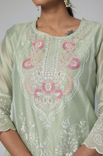 Detailed view of the subtle all-over embroidery work on the sleeve of the pestal green Chanderi kurti.
