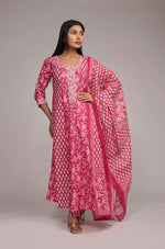 Side profile of model showcasing the voluminous flare and elegant drape of the printed pink Anarkali dupatta set.