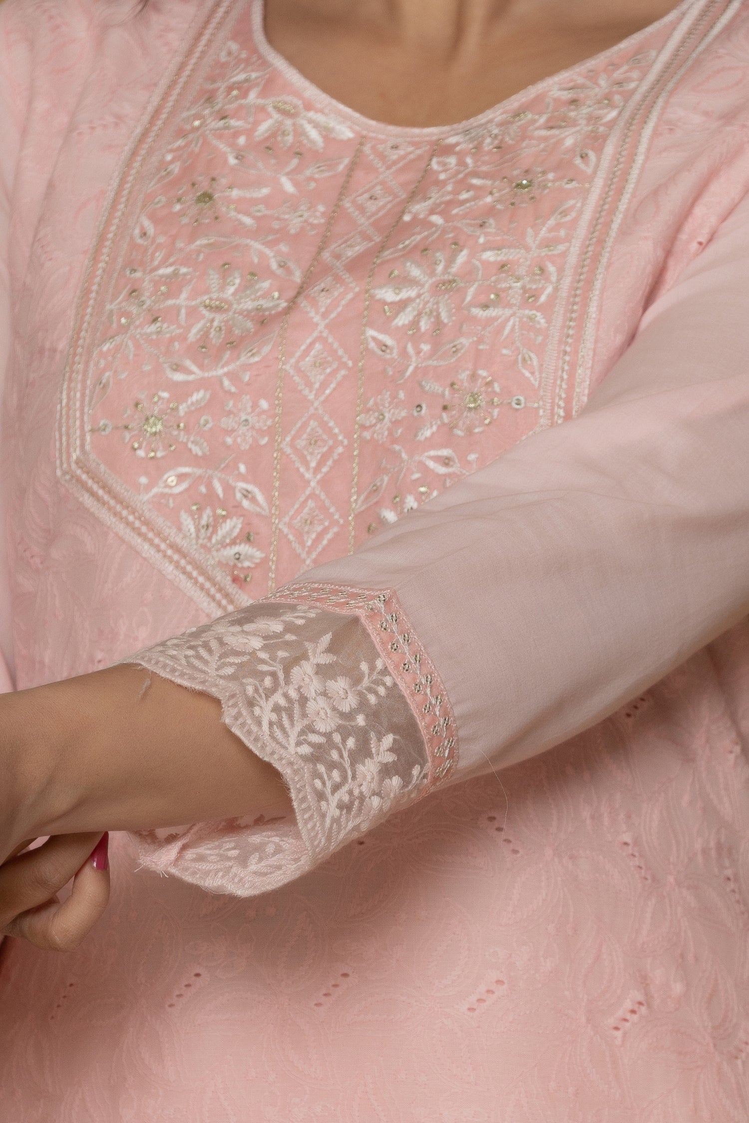 Detailed view of the sleeve and embroidered cuff on the pink cotton kurti, showcasing the subtle design elements.
