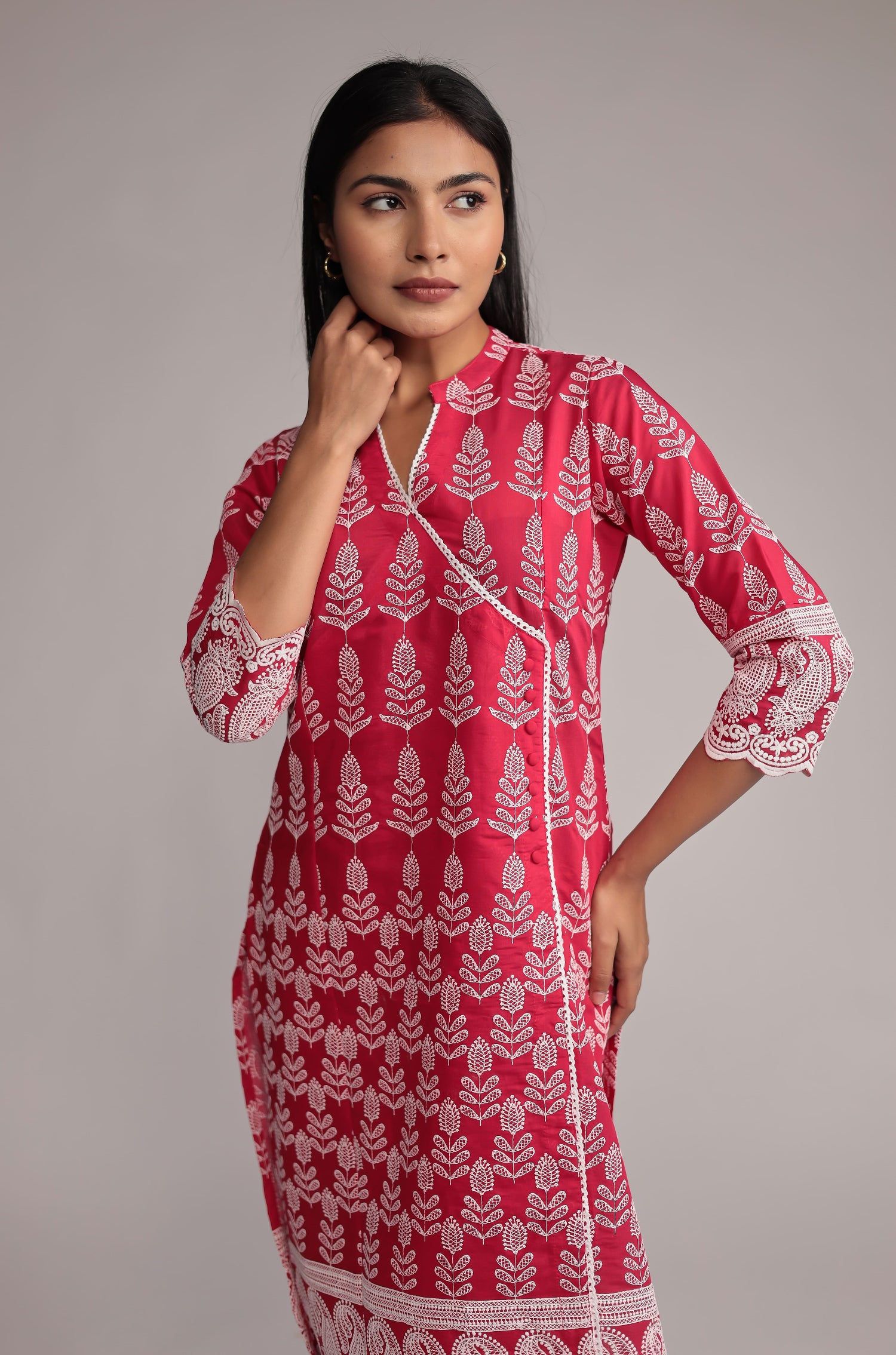Model in a confident stance, highlighting the full length and overall detailed design of the pink embroidered kurta pant set.

