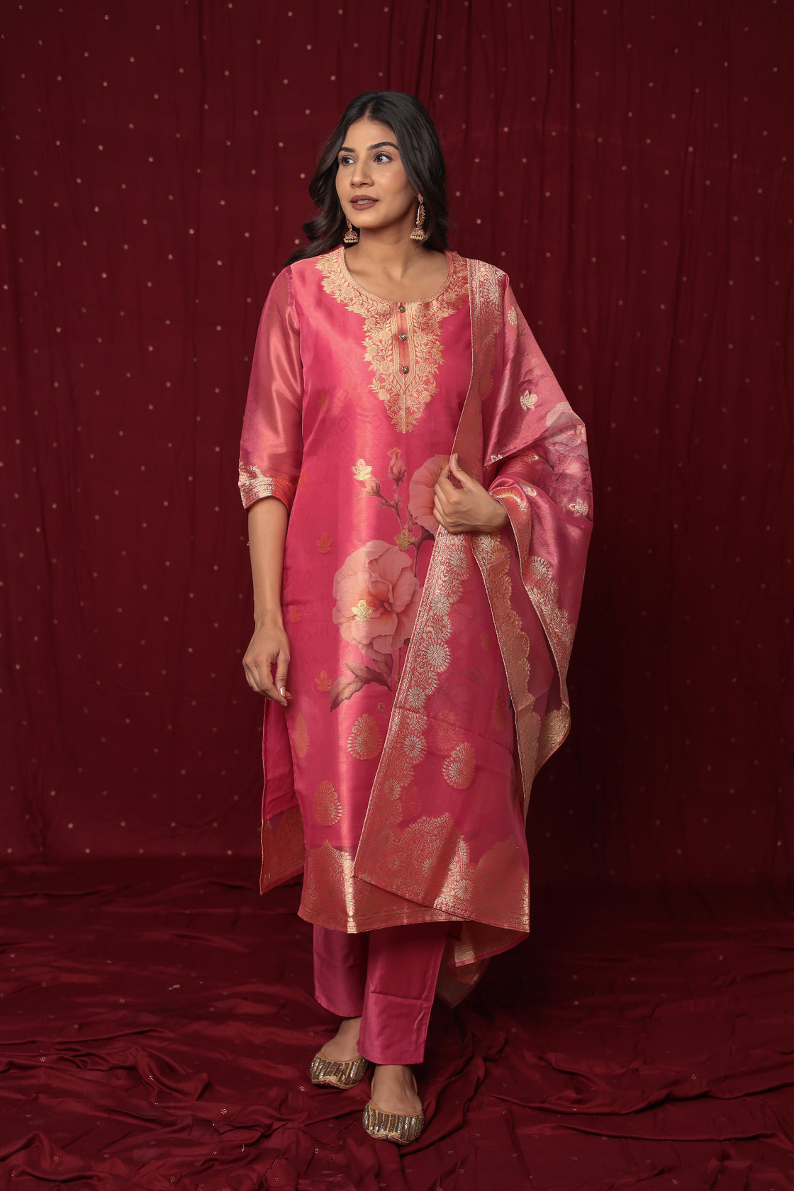 Side profile of model showcasing the graceful flow and rich look of the deluxe pink jacquard organza suit and dupatta.