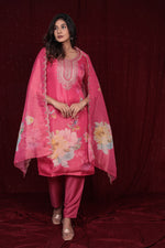 Side profile of model showcasing the flow and fit of the deluxe pink ethnic suit and organza dupatta.
