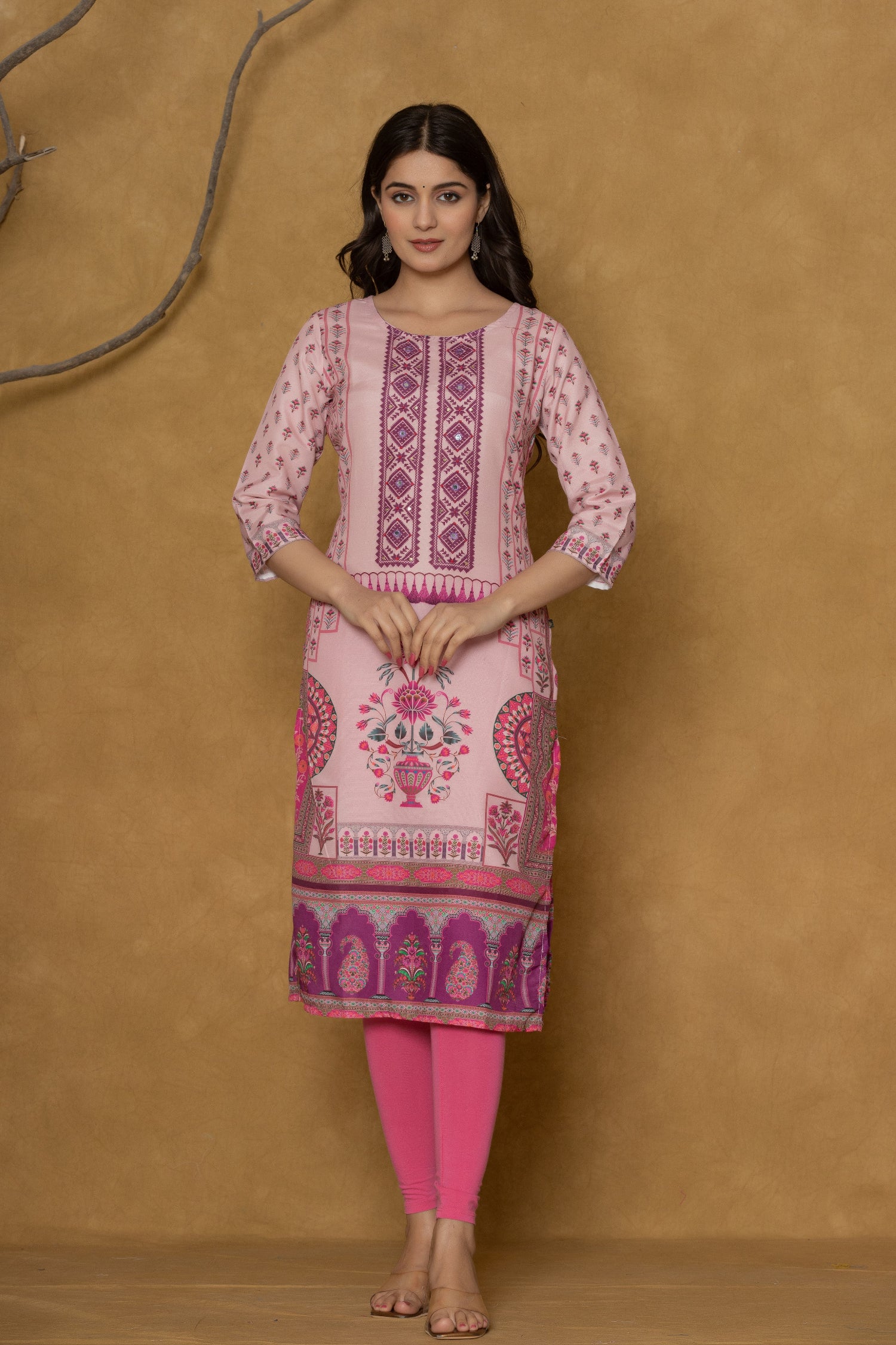 Model in a confident stance, highlighting the full length and overall detailed block print design of the pink kurta with handwork.