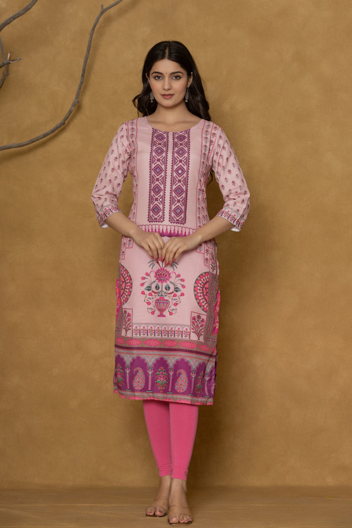 Model in a confident stance, highlighting the full length and overall detailed block print design of the pink kurta with handwork.