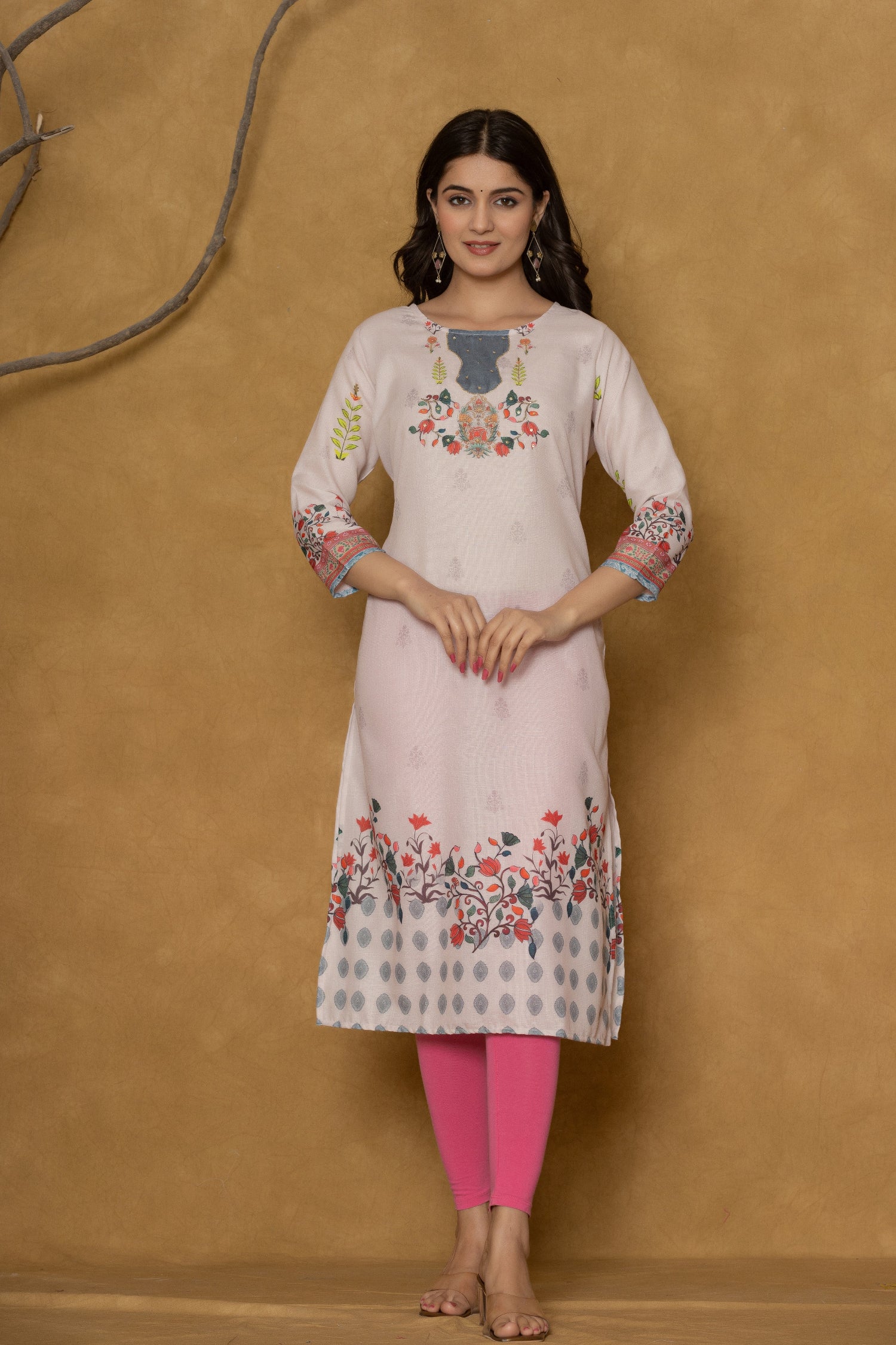 Close-up of the delicate floral and geometric pattern along the hemline of the pink pannel kurta, showcasing the fabric and design detail.
