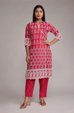 Model wearing a vibrant pink kurta pant set from The Navra, featuring intricate allover embroidery on the kurta and comfortable matching pants. Ideal for stylish daily or festive wear.