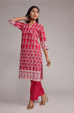 Model gracefully posing in the pink kurta pant set, showcasing the comfortable movement and elegance of the allover embroidered kurta.