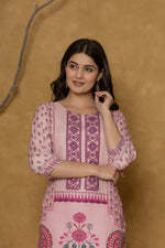 Side profile of model showcasing the comfortable fit and elegant block print design of the pink kurta with handwork detailing.