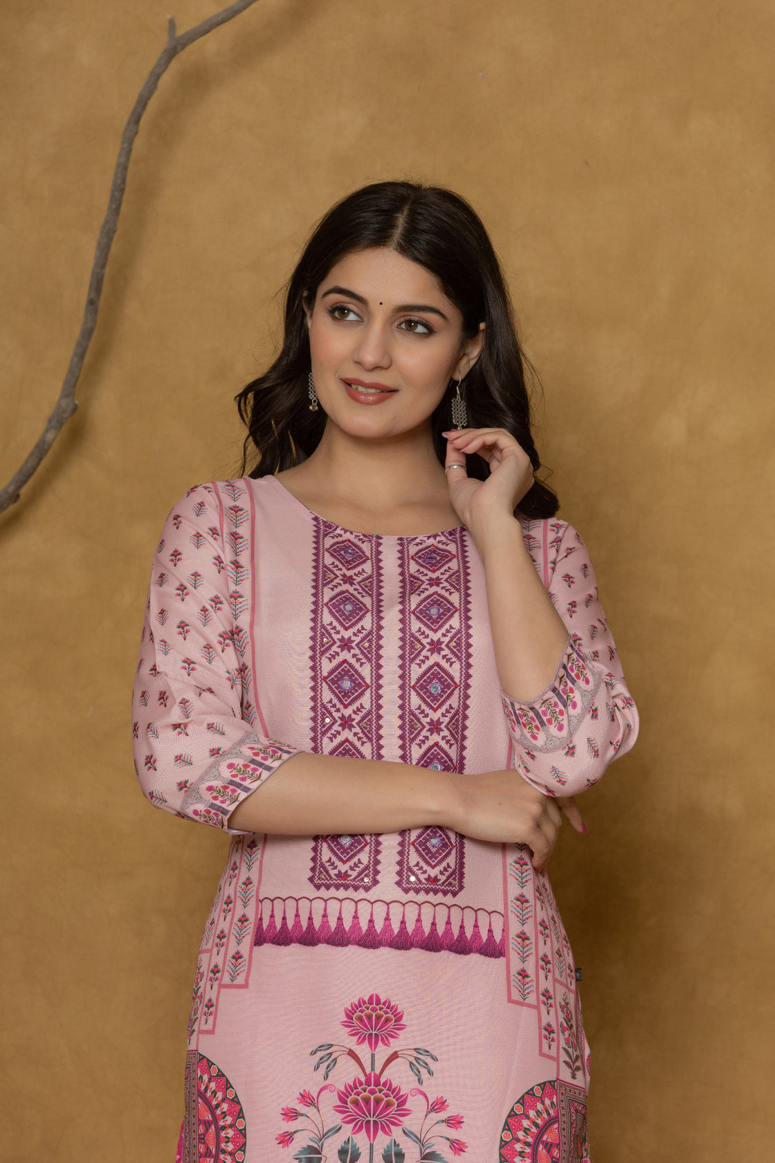 Side profile of model showcasing the comfortable fit and elegant block print design of the pink kurta with handwork detailing.