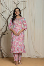 Detailed view of the multicolor mill print and embroidery detailing on the upper body of the pink cotton kurta.