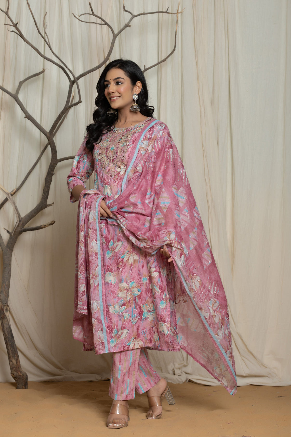 Side profile of model showcasing the comfortable fit and elegant drape of the pink cotton premium mill print dupatta set with embroidery.