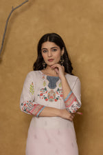 Side profile of model showcasing the comfortable fit and subtle elegance of the pink pannel kurta.