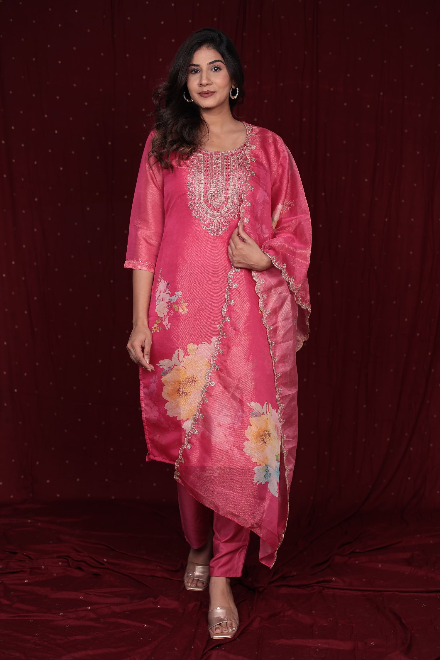 Model gracefully wearing the deluxe shimmer organza pink suit in a festive setting, perfect for parties and celebrations.