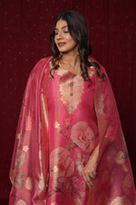 Close-up of the intricate gold jacquard weaving and delicate embroidery on the neckline of the pink organza kurti.