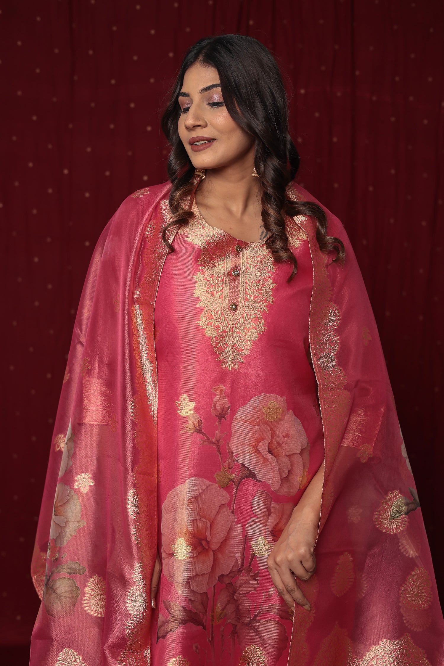 Close-up of the intricate gold jacquard weaving and delicate embroidery on the neckline of the pink organza kurti.