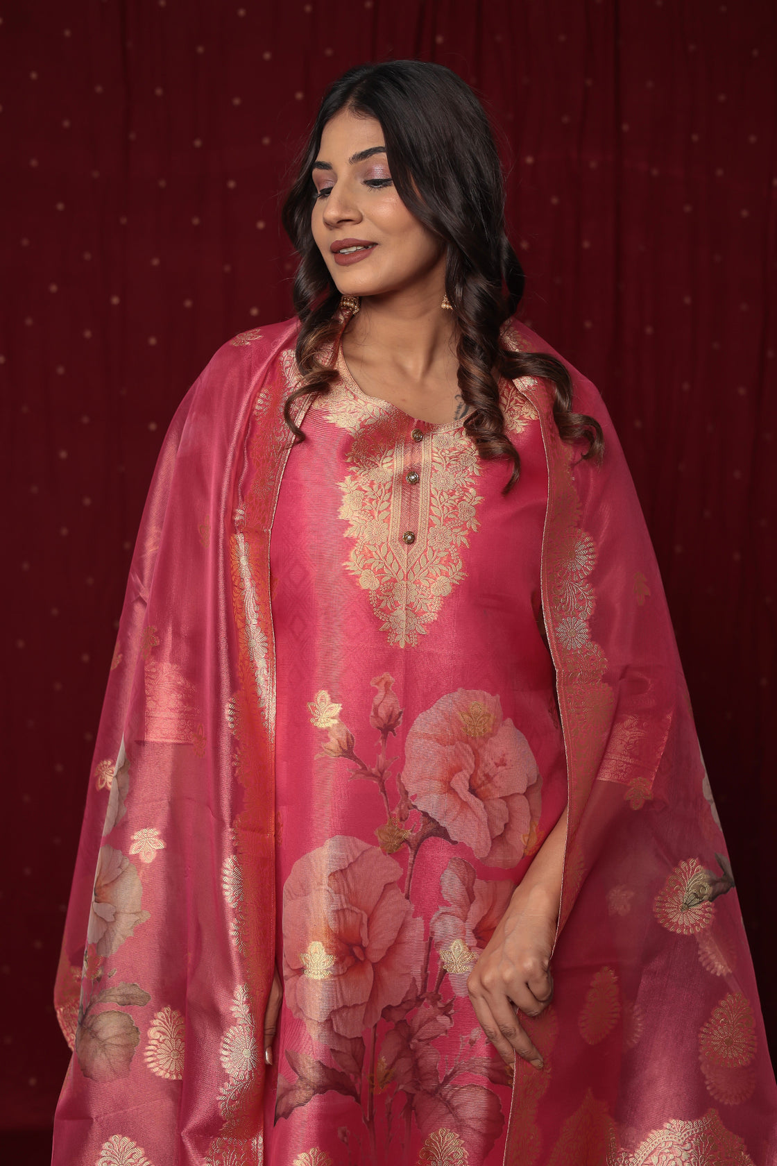 Close-up of the intricate gold jacquard weaving and delicate embroidery on the neckline of the pink organza kurti.