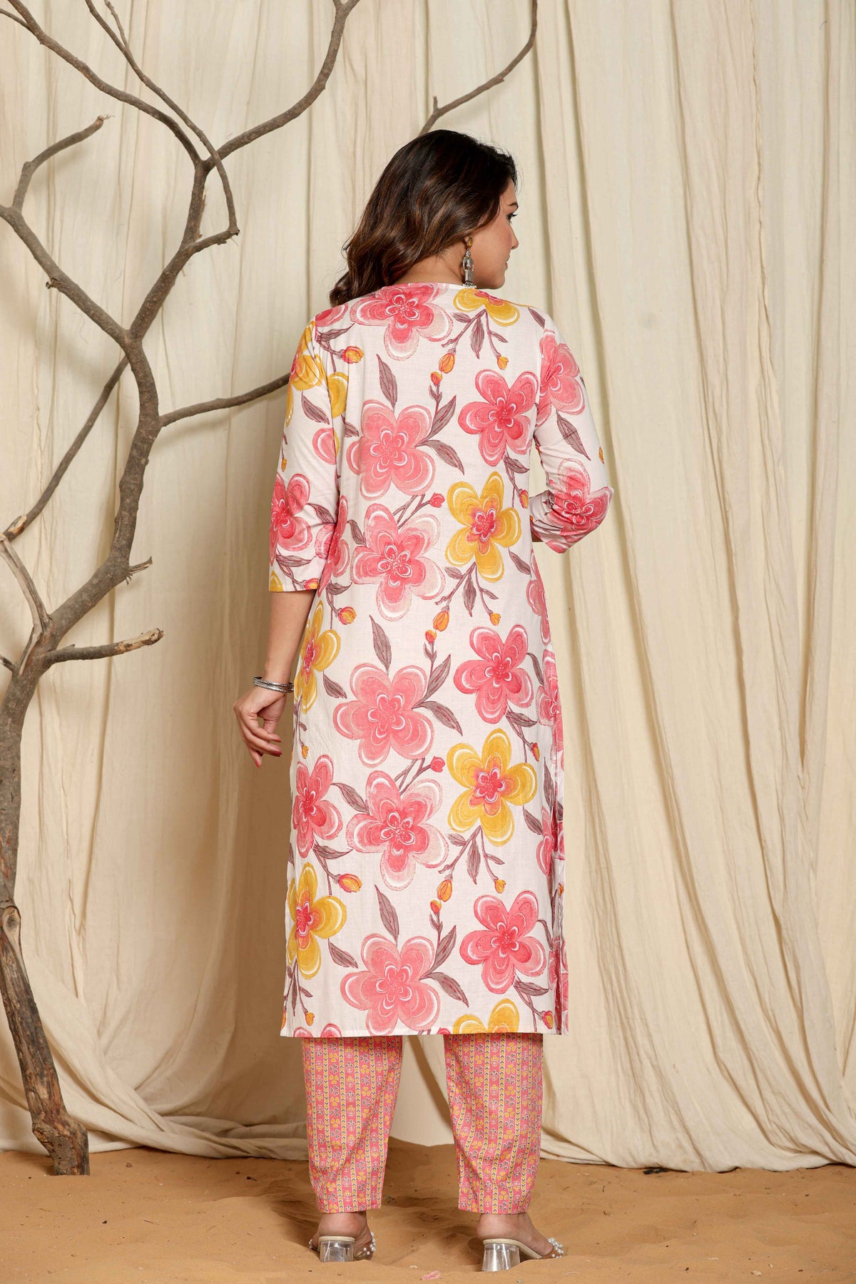 Detailed view of the vibrant pink, yellow, and orange floral print on the upper body of the pink cotton kurta.