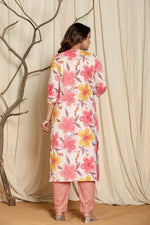 Detailed view of the vibrant pink, yellow, and orange floral print on the upper body of the pink cotton kurta.