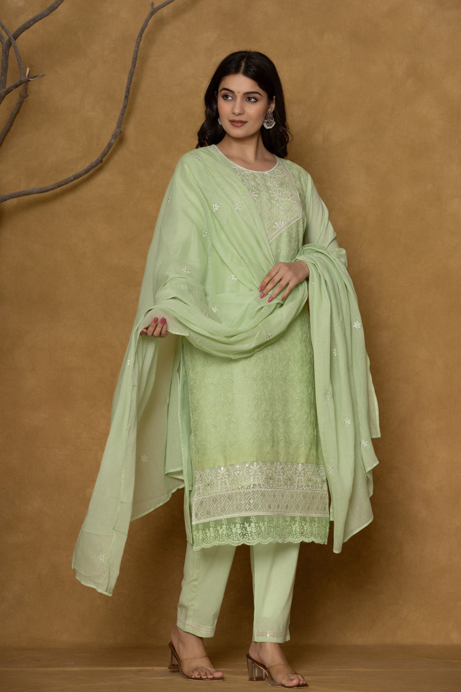 Model wearing a premium 100% cotton Chifley dupatta set from The Navra in light green, featuring delicate white embroidery on the kurti, a matching textured dupatta, and comfortable pants. Ideal for comfortable daily or casual wear.