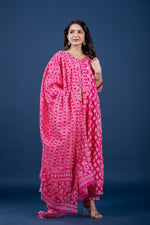 Model wearing a vibrant fuchsia pink printed Anarkali dupatta set from The Navra, featuring a flowing Anarkali kurta with intricate geometric print and a matching patterned dupatta. Ideal for comfortable festive or elegant casual wear.