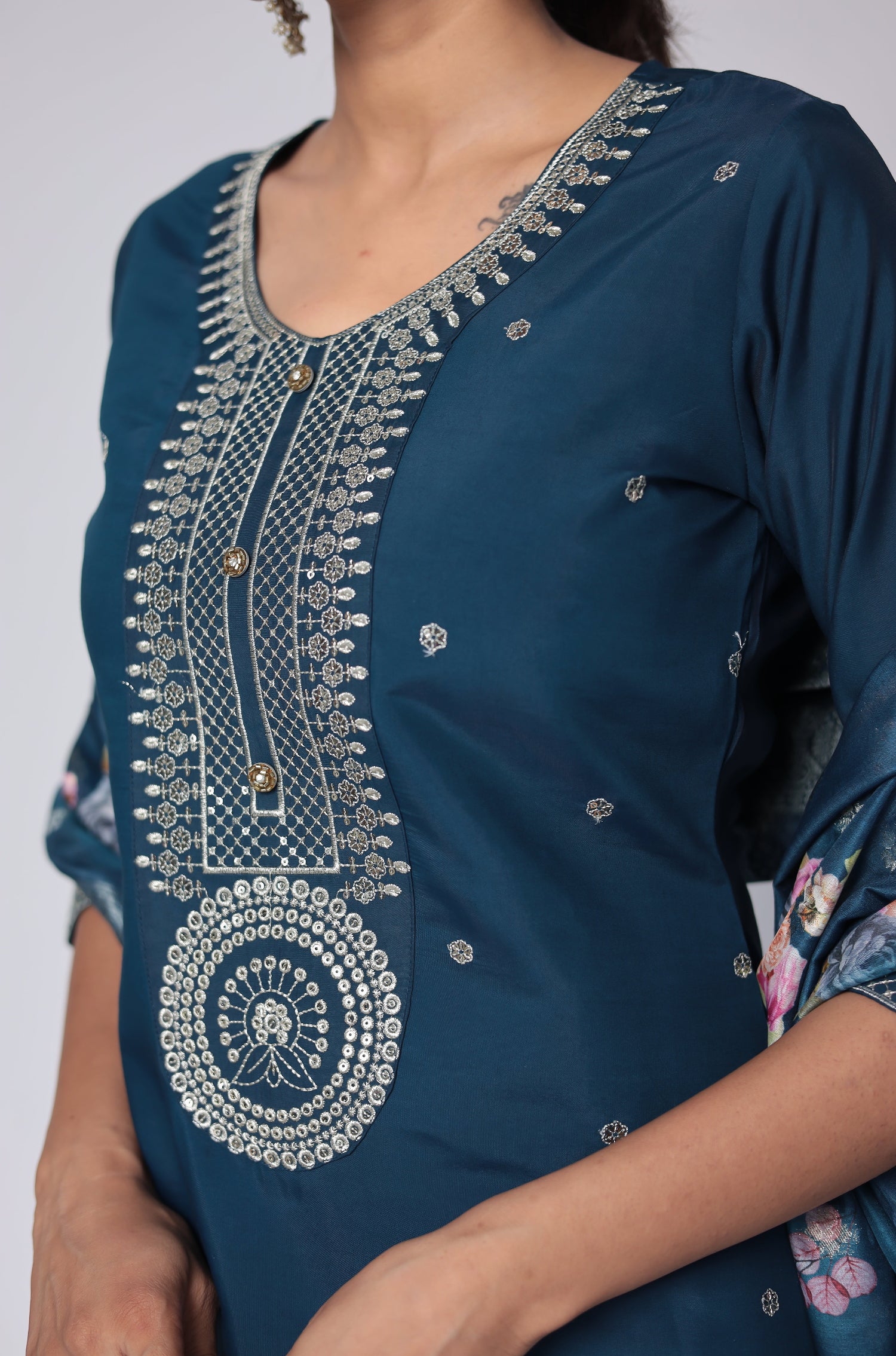 Detailed view of the vibrant floral print and woven jacquard pattern on the luxurious blue dupatta, from the soft silk suit set.