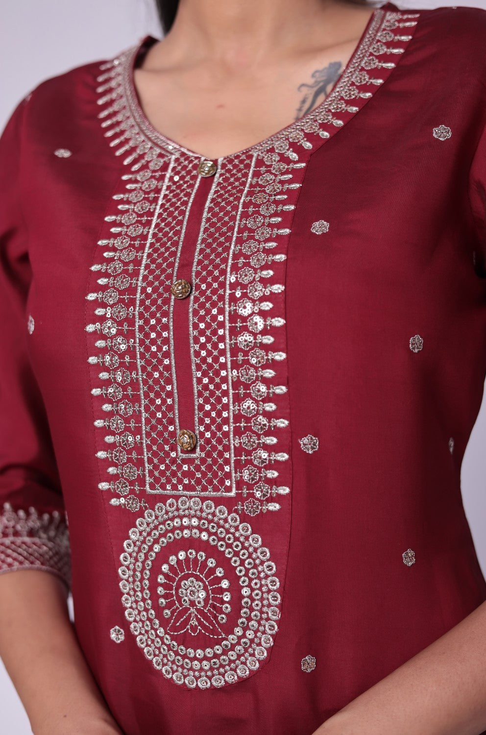 Detailed view of the vibrant floral print and woven jacquard pattern on the luxurious maroon dupatta, from the silk suit set.