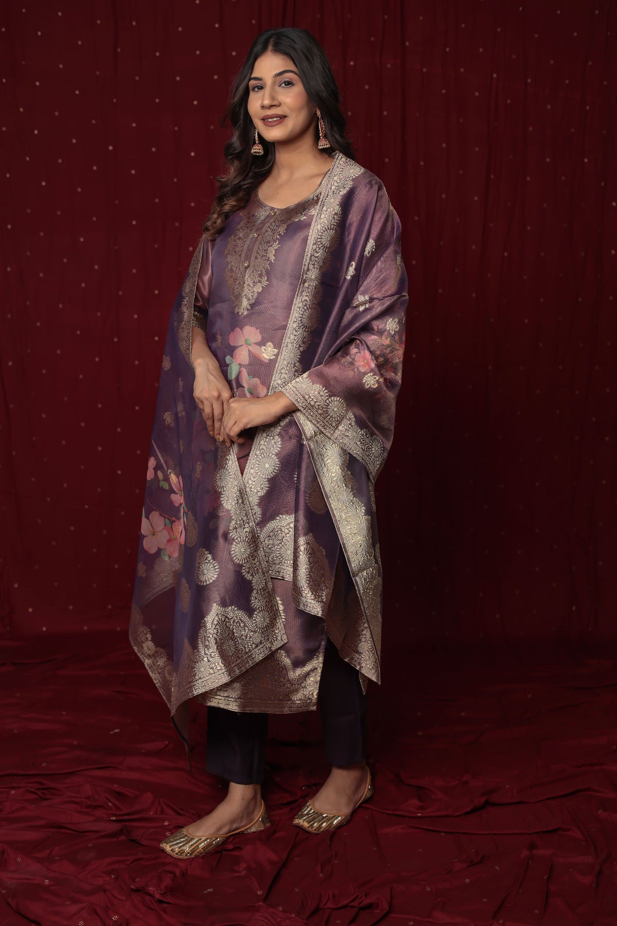 odel in a confident stance, highlighting the full length and overall rich design of the Deluxe Jacquard Organza purple suit set, with dupatta.