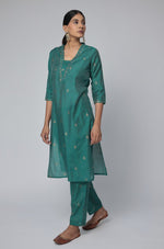 Model gracefully posing in the Rama Green Chanderi Silk co-ord set, showcasing the comfortable movement and elegant flow of the outfit.

