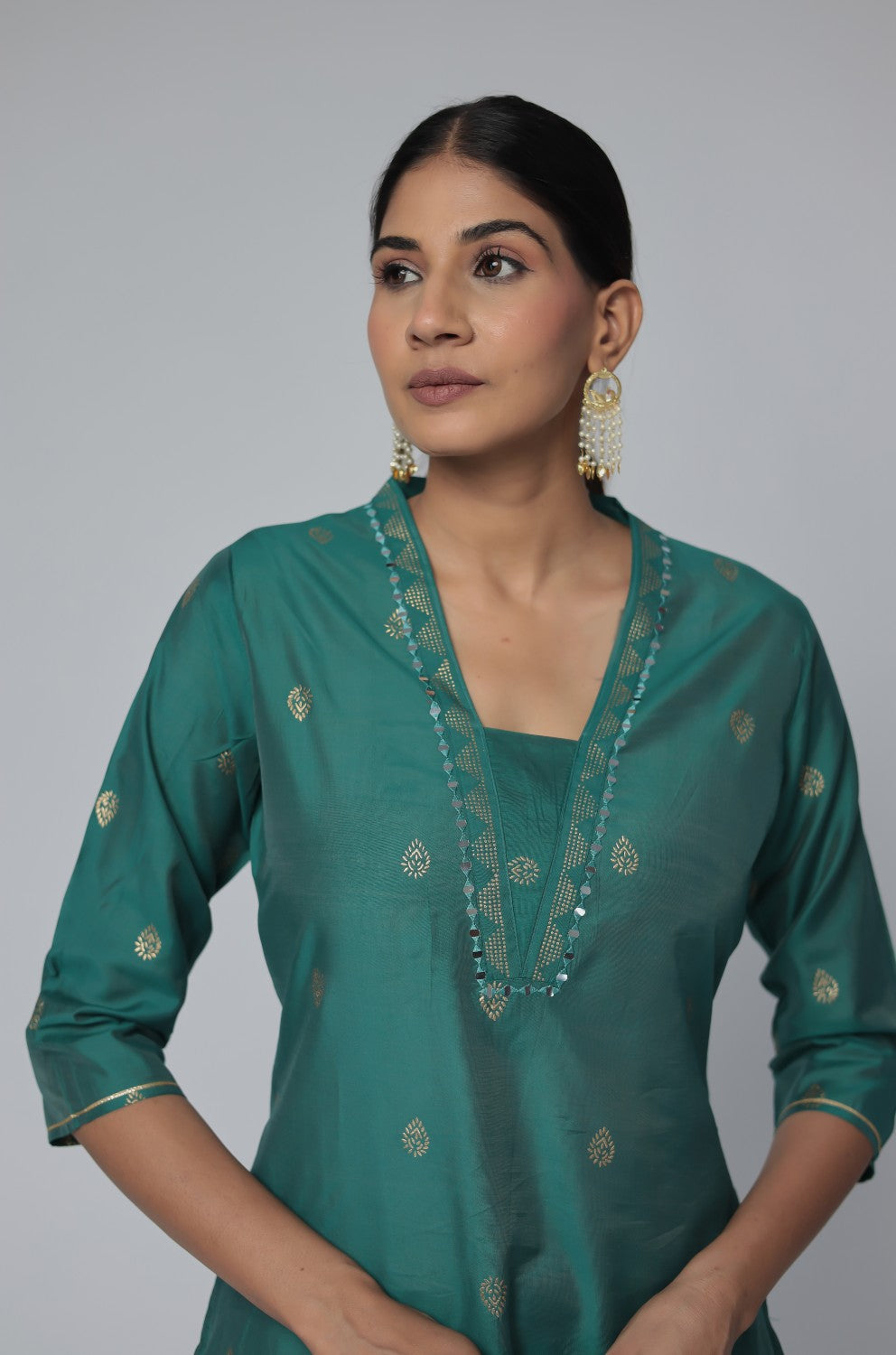 Side profile of model showcasing the comfortable fit and elegant drape of the Rama Green Chanderi Silk co-ord set with subtle gold motifs.