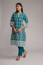 Side profile of model showcasing the comfortable fit and detailed allover sleek embroidery of the Rama green pant set.