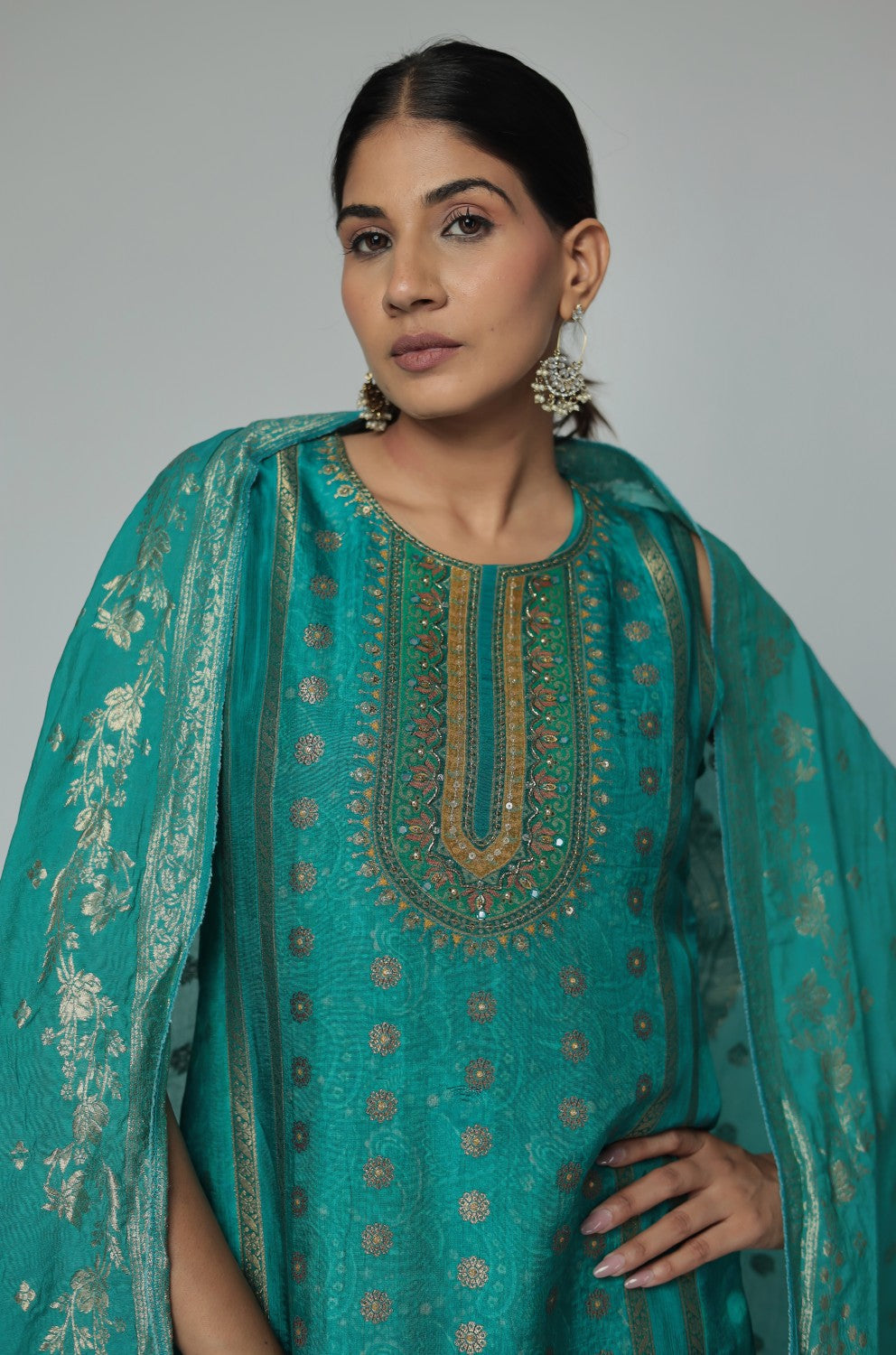 Side profile of model showcasing the comfortable fit and elegant drape of the Rama Green Banarasi Jacquard Chanderi suit set with its woven jacquard dupatta.