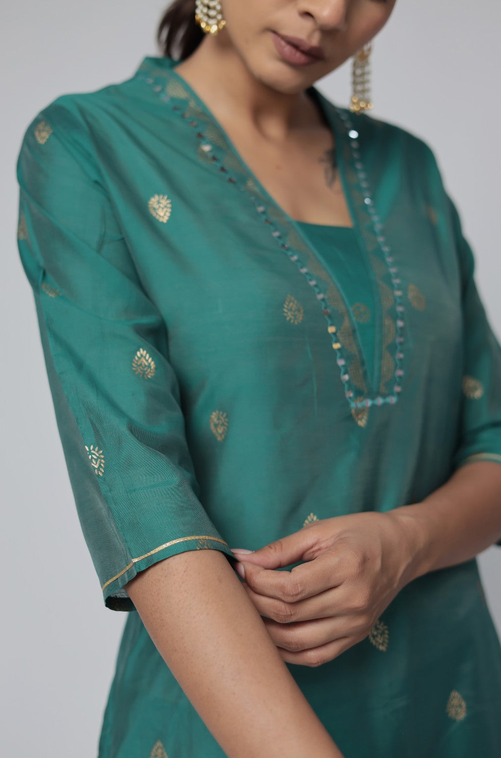 Detailed view of the sleeve and fabric of the Rama Green Chanderi Silk kurta, showcasing the subtle gold motifs woven into the material.