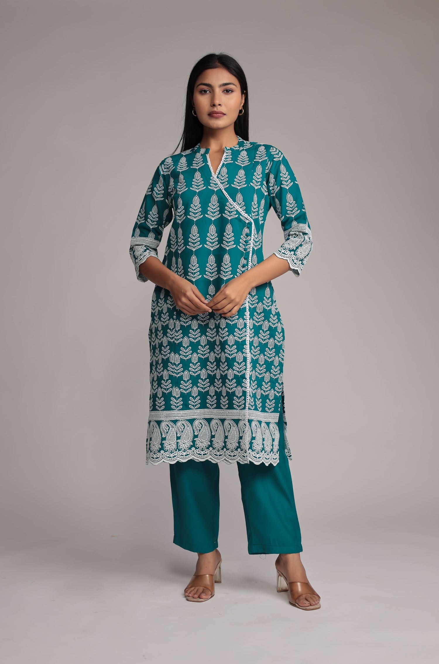 Model wearing a vibrant Rama green pant set from The Navra, featuring intricate allover sleek embroidery on the kurta and comfortable matching straight pants. Ideal for daily or semi-formal ethnic wear.