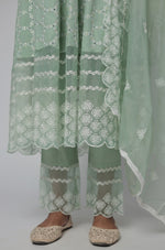 Detailed view of the sage green Chikankari Anarkali kurta and cotton pant, highlighting the all-over white embroidery and fabric texture.
