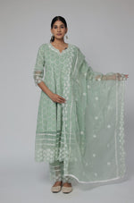 Model in a relaxed stance, highlighting the full length and comfortable design of the sage green Chikankari Anarkali kurta set.