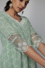 Detailed view of the intricate white Chikankari embroidery on the sleeves of the sage green Anarkali kurta.