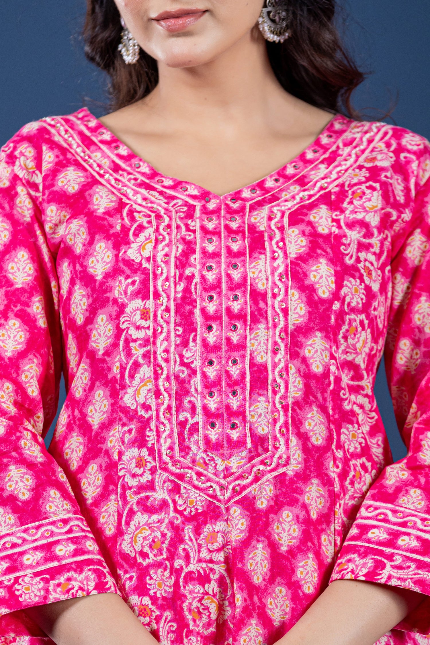 Close-up of the V-neckline and intricate geometric print on the upper body of the fuchsia pink Anarkali kurta, highlighting pattern detail.